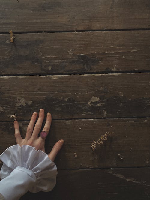 Free Person's Hand on Wood Surface  Stock Photo