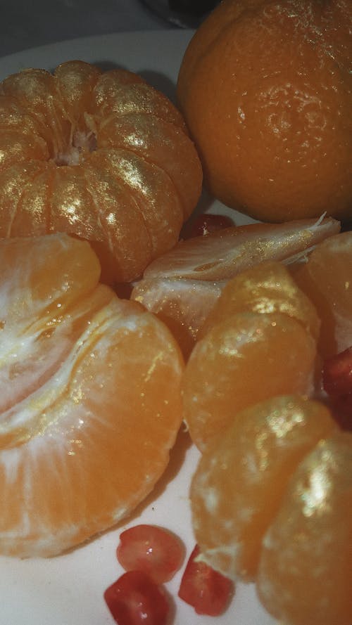 Peeled Orange Fruits on White Ceramic Plate