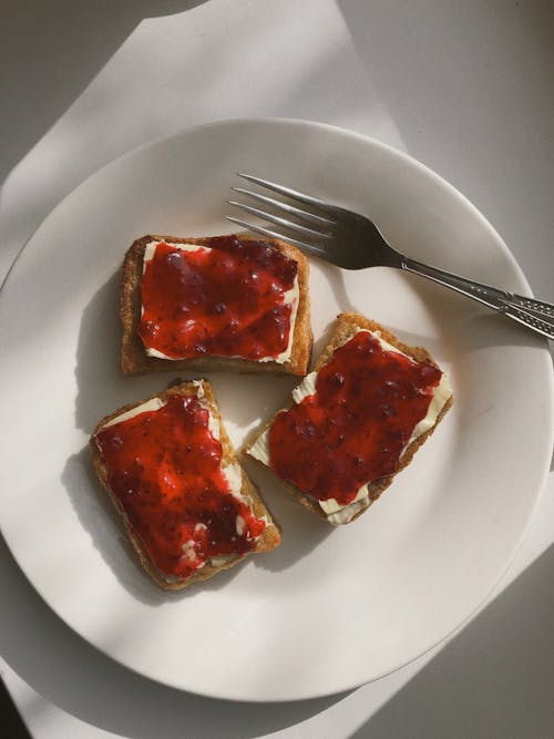 Free Toasted Bread Slices with Jam for Brunch Laying on Plate Stock Photo