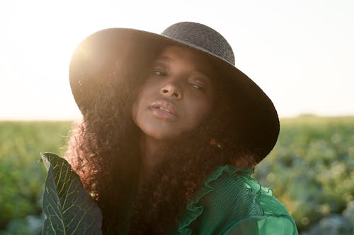 Portrait of Curly Haired Woman in Hat