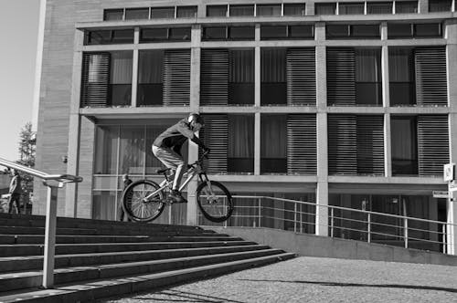 Biker Performing a Stunt Over Outdoor Steps