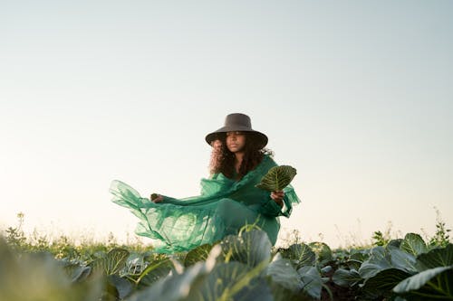 Woman in Green Dress Standing in Cabbage Field