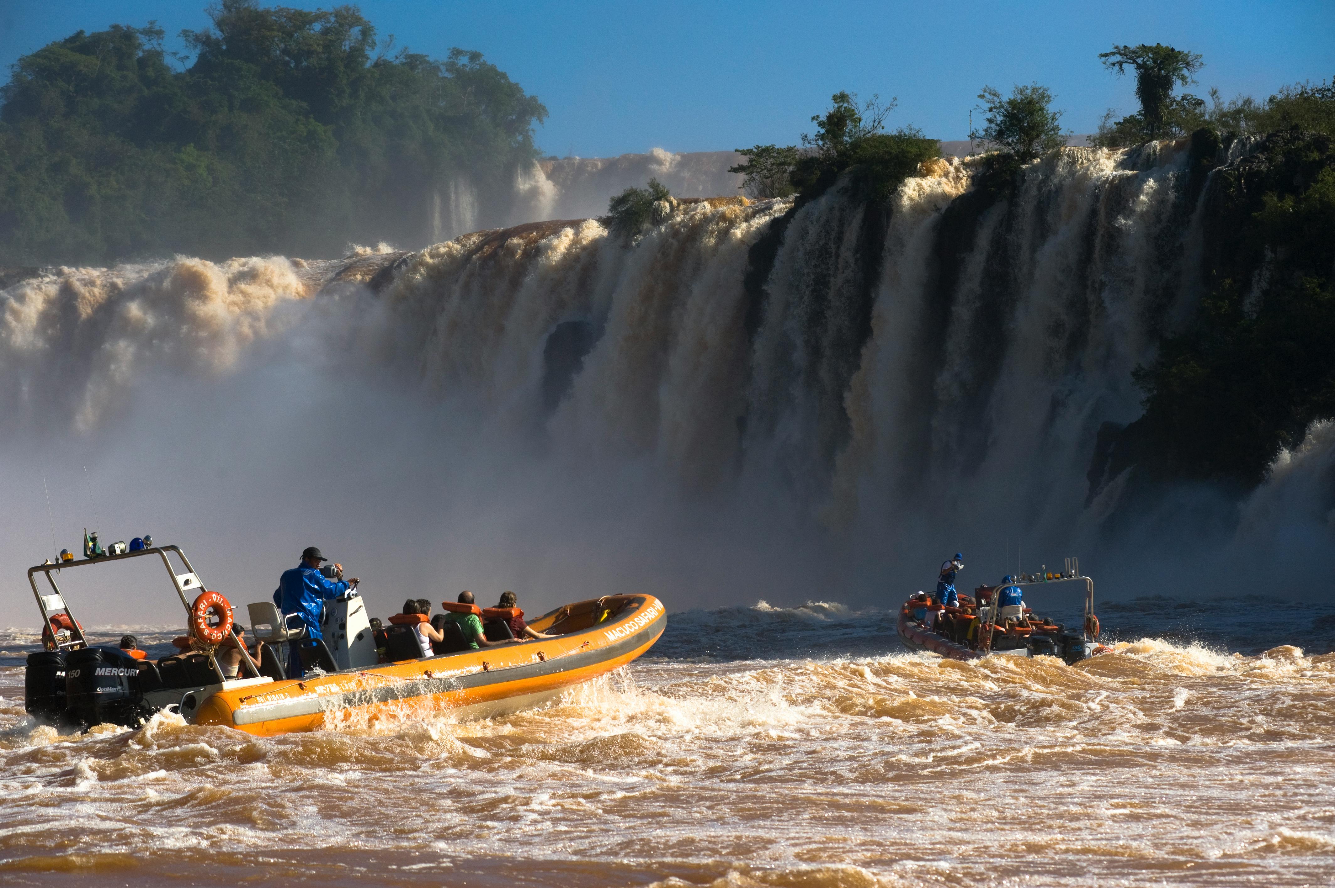 People Riding Motorized Rubber Rafts in