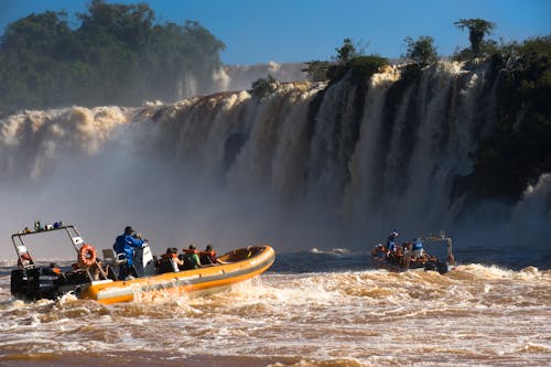 People Riding Motorized Rubber Rafts in the Rapid