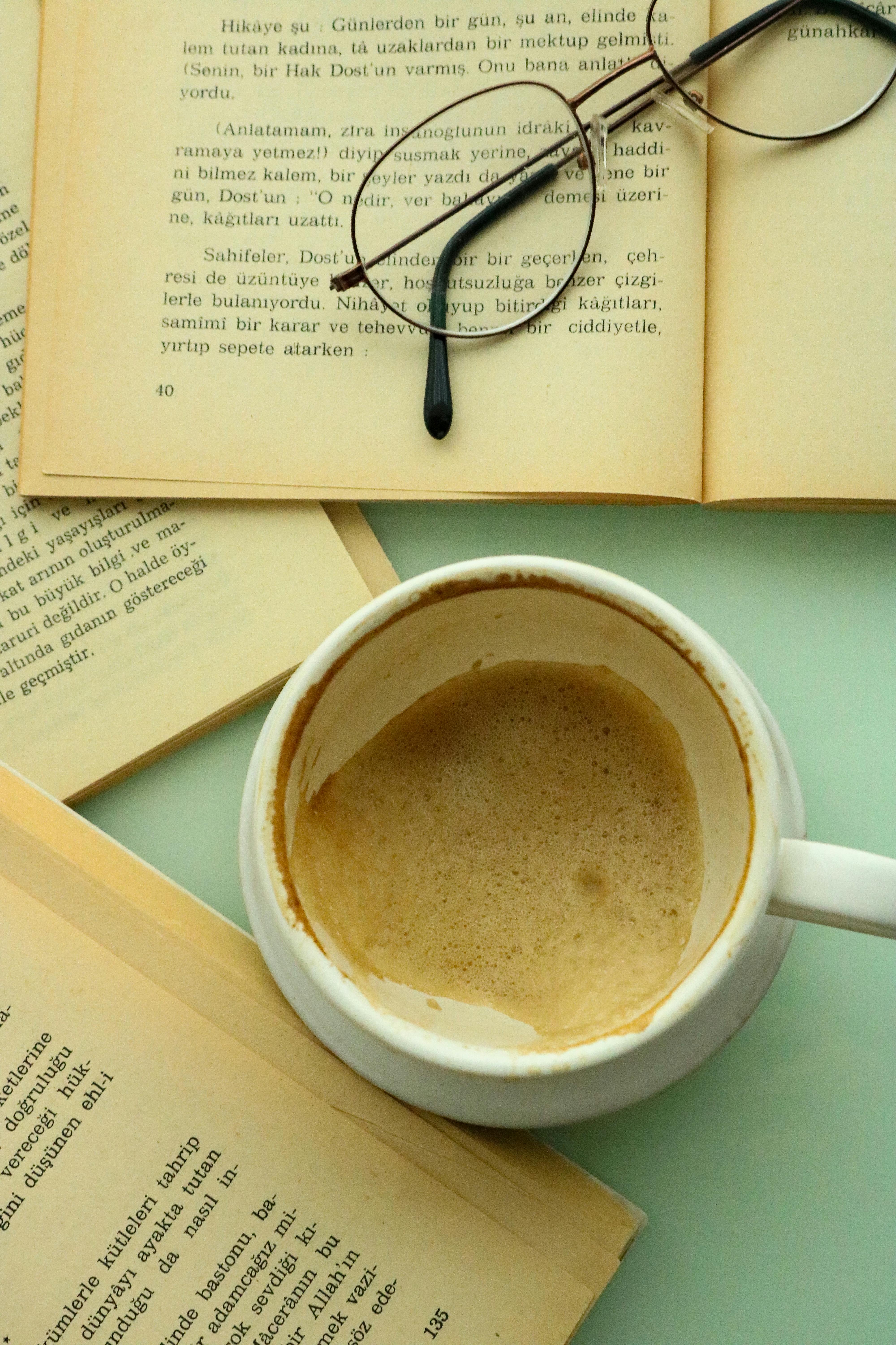 cup of coffee i between open books