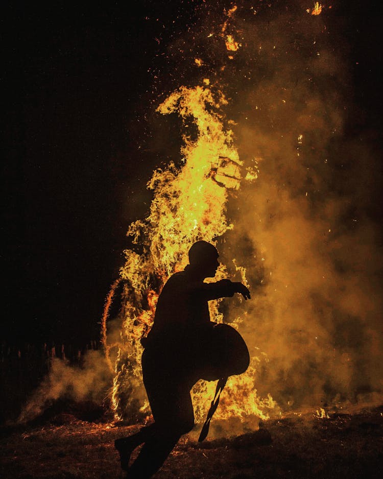 Person Silhouette Near The Fire