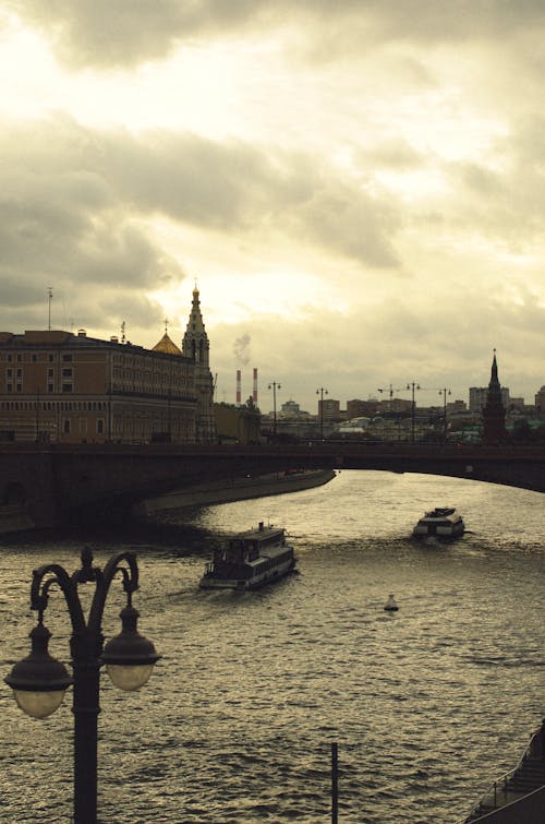 People Riding on Boat on Water Near Buildings