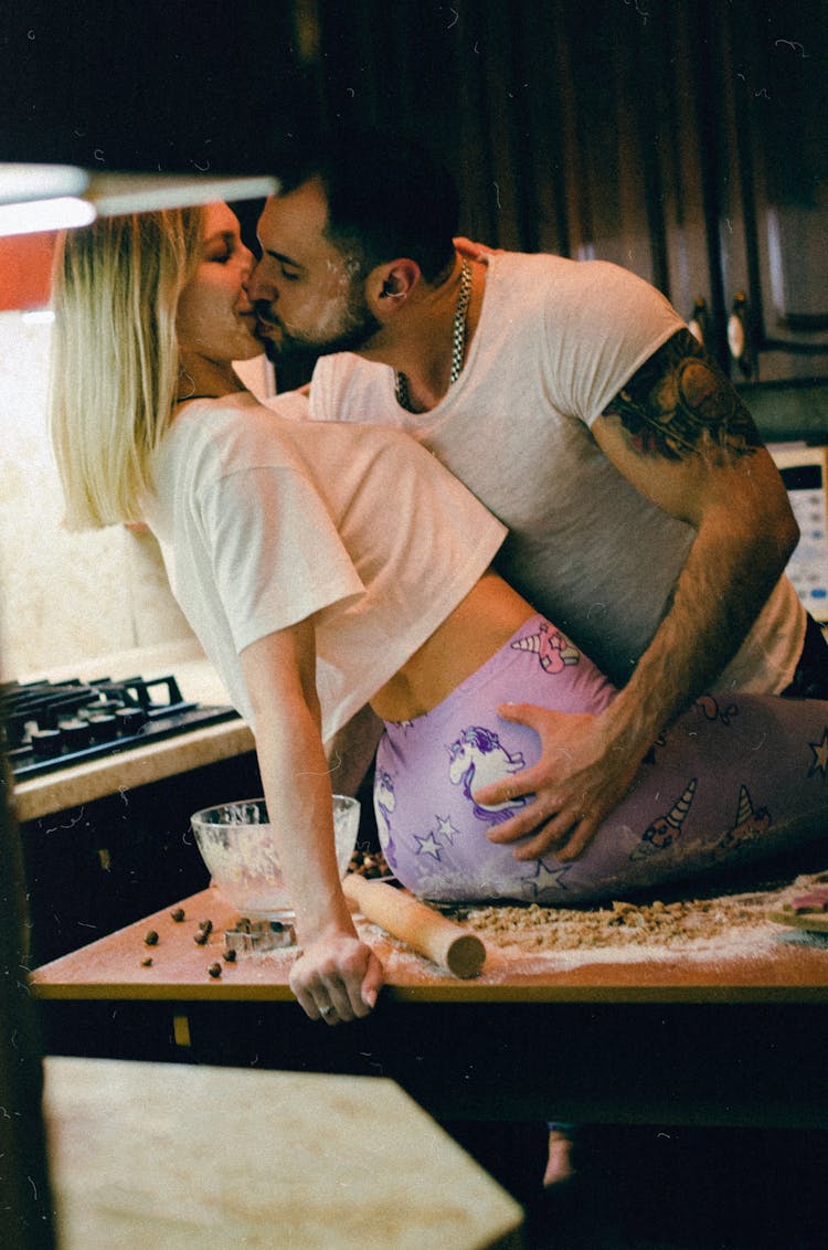 A Couple Kissing In The Kitchen