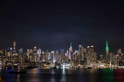 Stunning view of New York City skyline with illuminated skyscrapers at night.