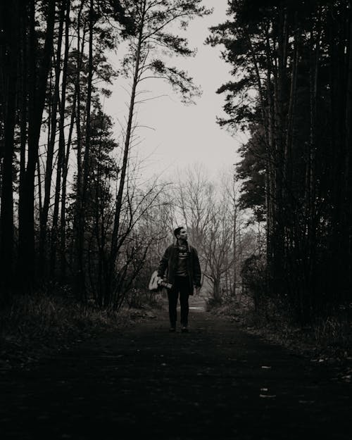 Free Person in Black Jacket Standing on Forest Stock Photo