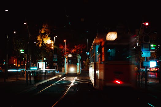 Dynamic night scene of trams on illuminated streets in Budapest.