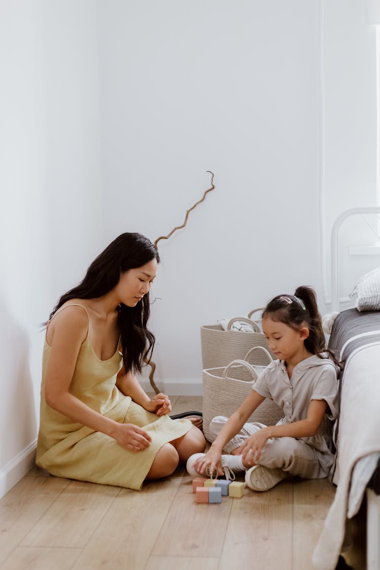 Mother And Daughter Playing With Blocks