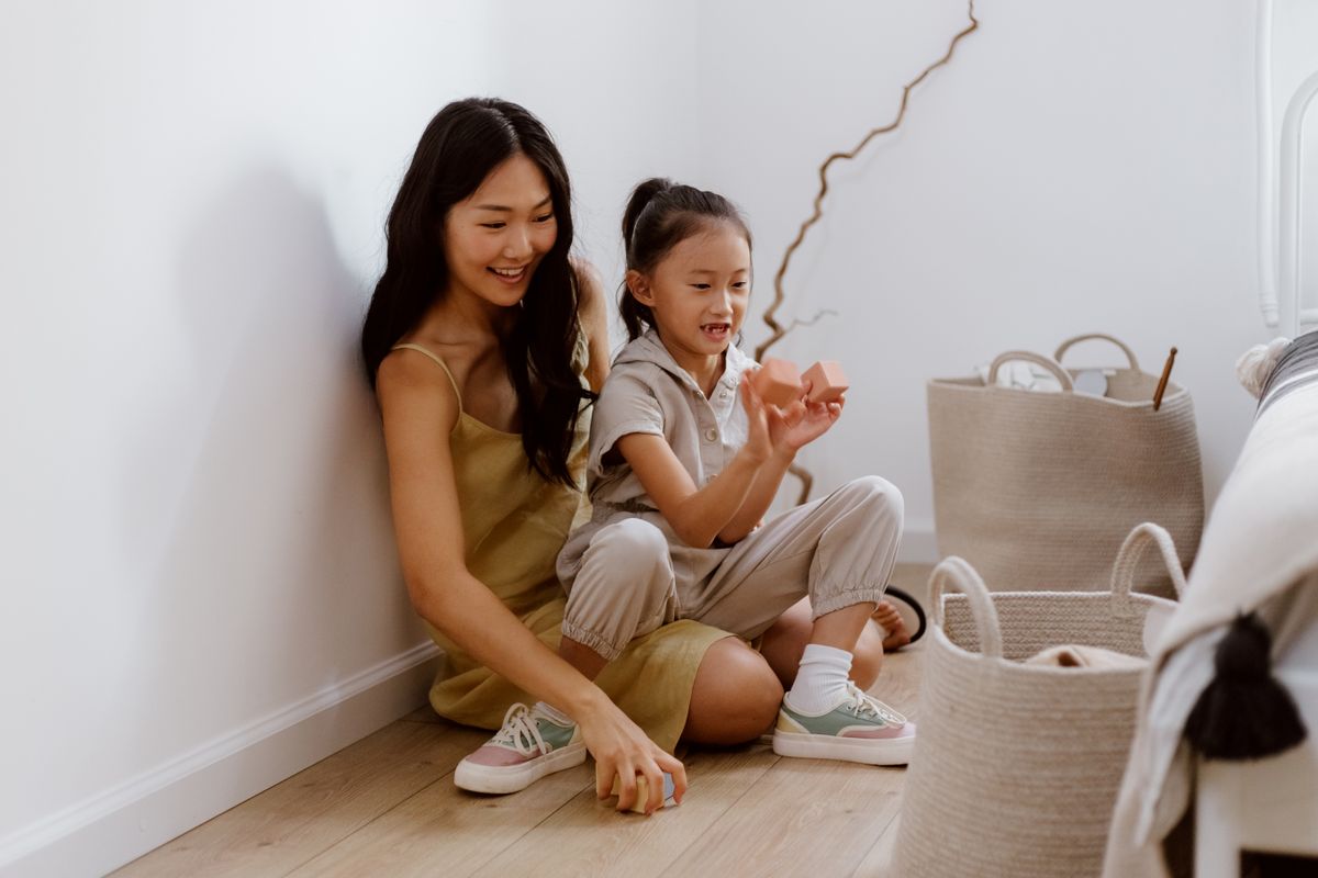 Adult and child enjoying play together with building blocks