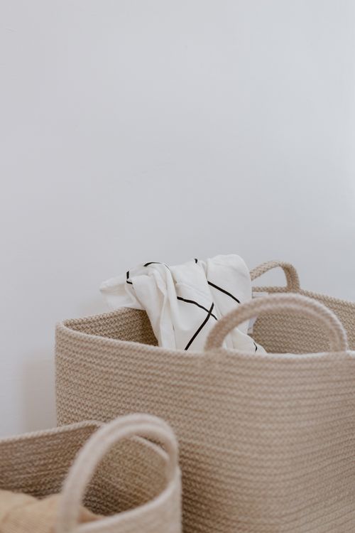 Storage baskets with rolled linens — photo by Ron Lach on Pexels