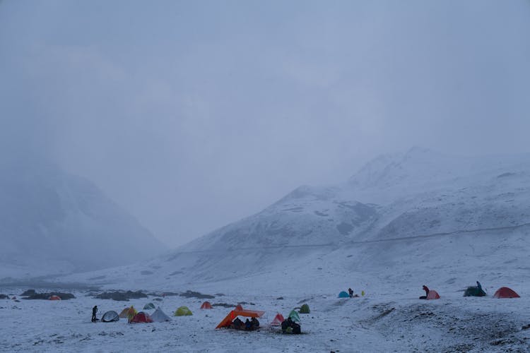 People Camping On A Snow Covered Mountain