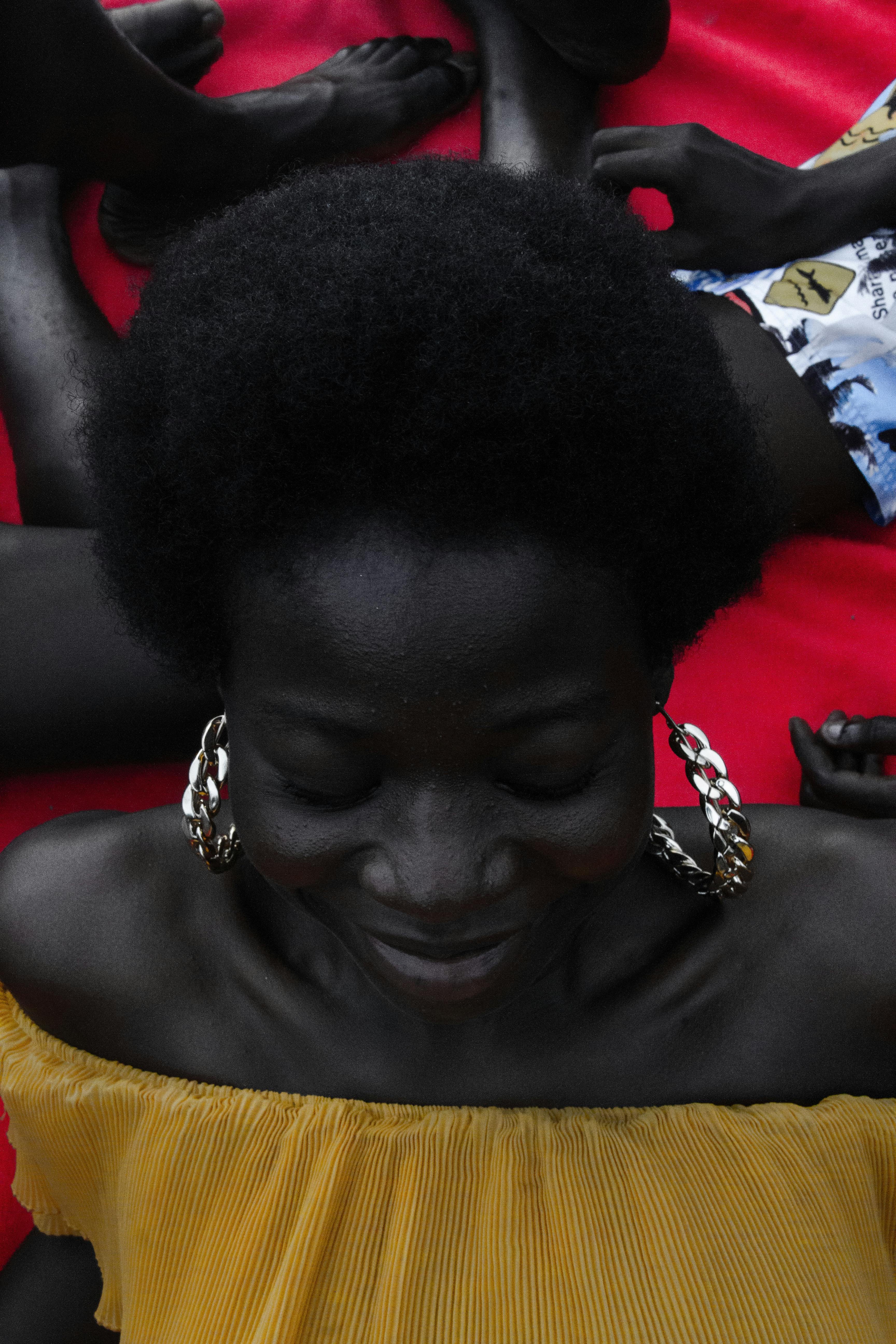 afro american woman in yellow summer dress and big earrings