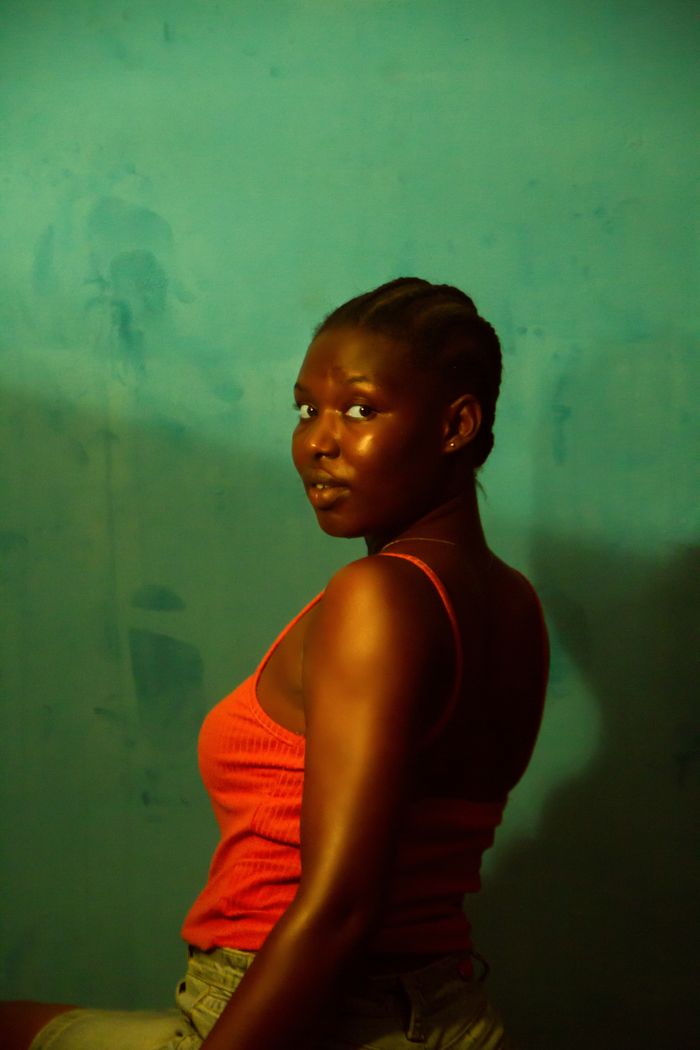 Studio portrait in profile against a teal wall, photo by Hashtag Melvin on Pexels