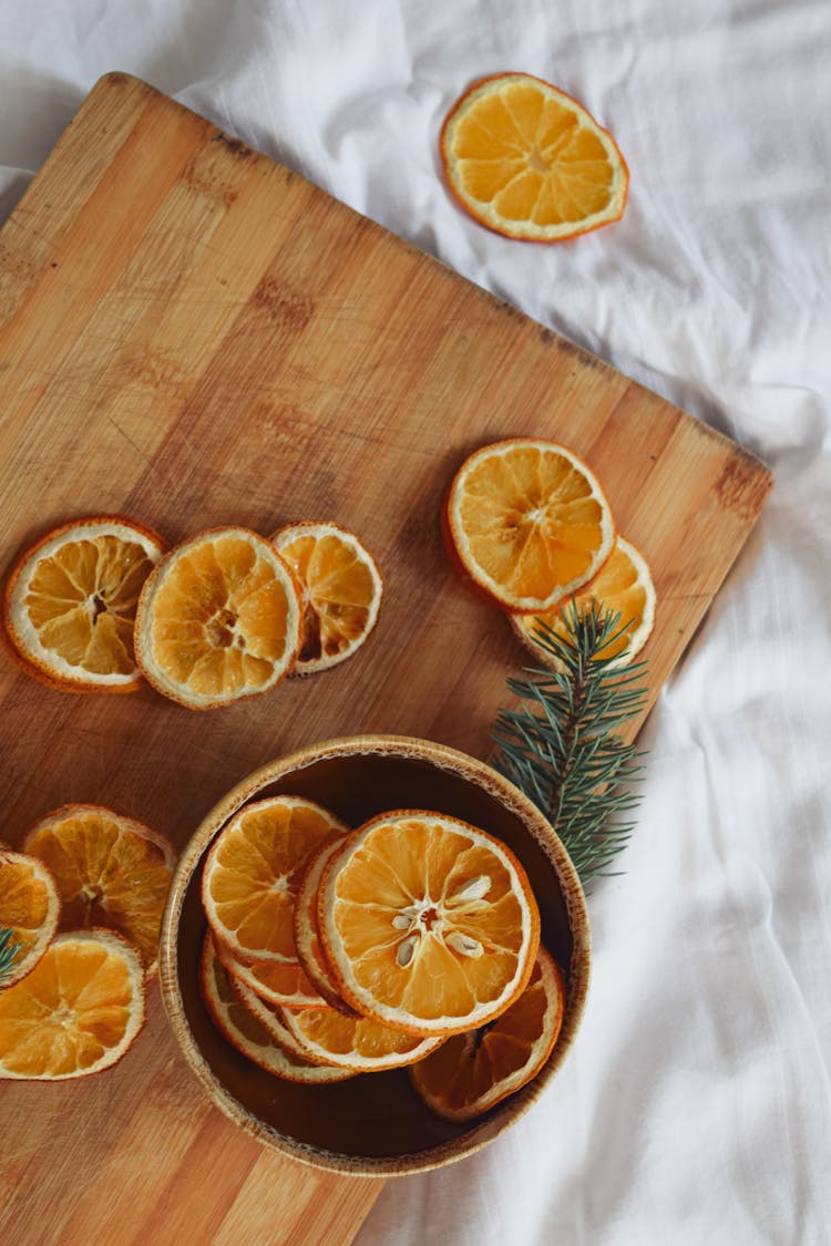 Sliced Clementine Fruit On A Wooden Chopping Board