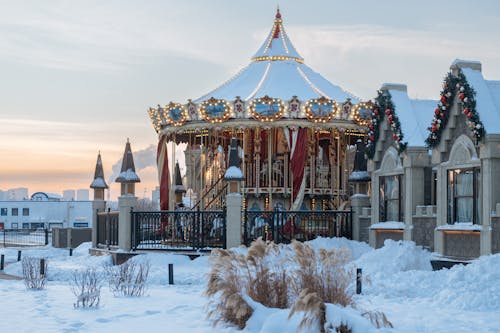 A Beautiful Carousel on a Snow Covered Ground