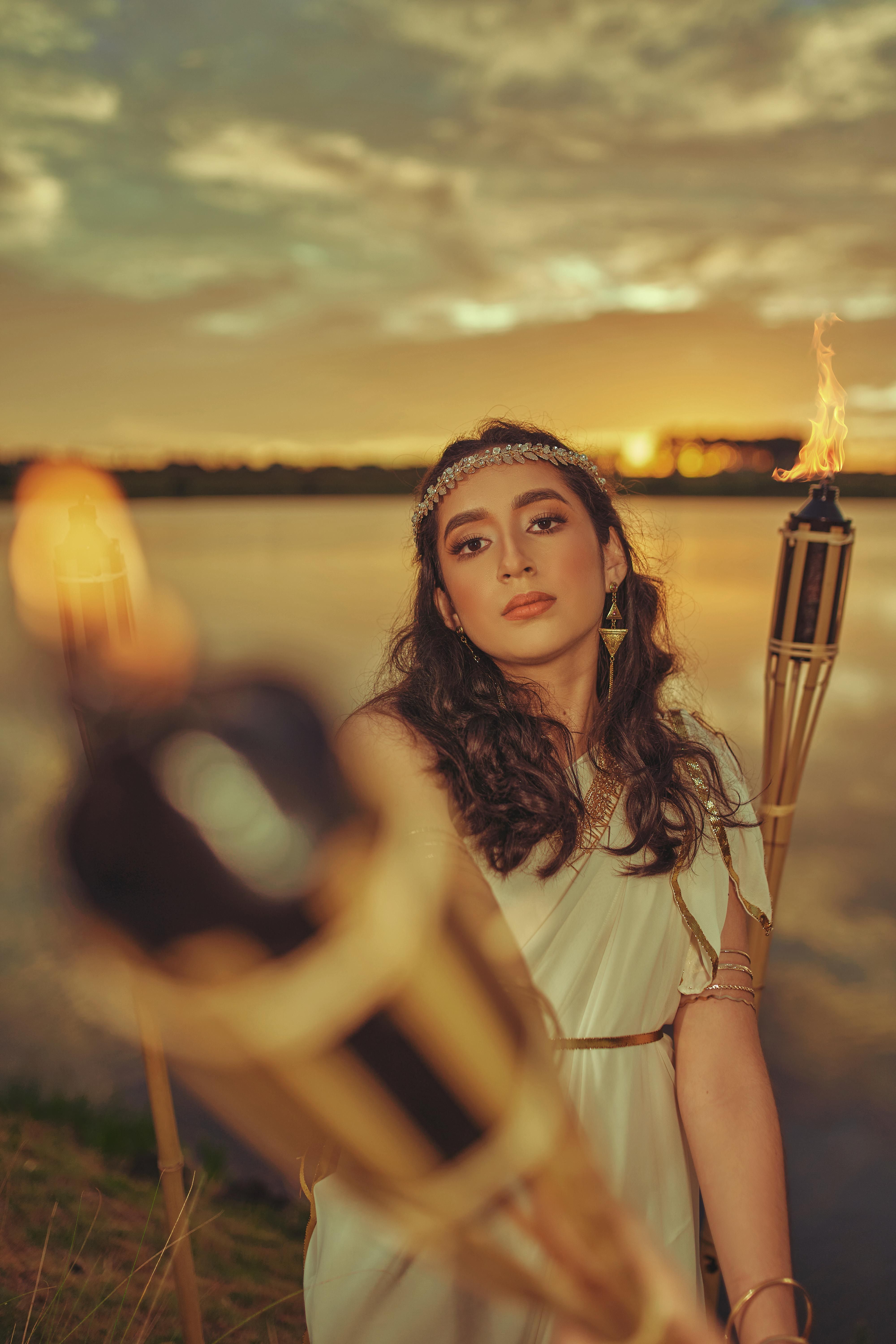 A Woman in White Sleeveless Dress Holding Torch · Free Stock Photo