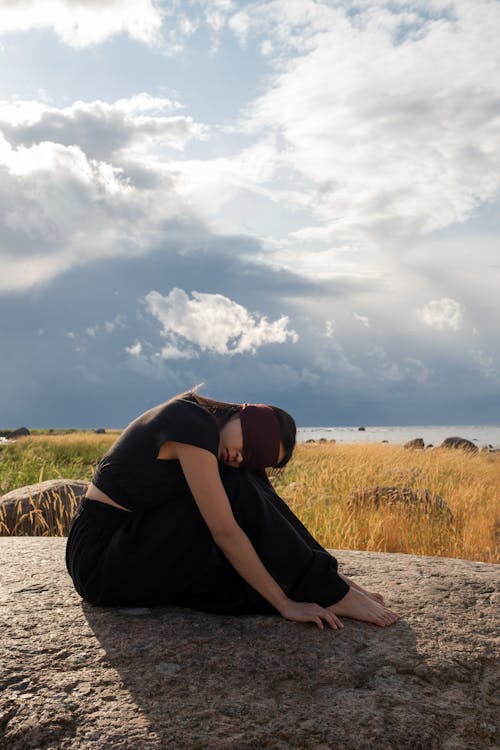 Blindfolded Woman on a Rock