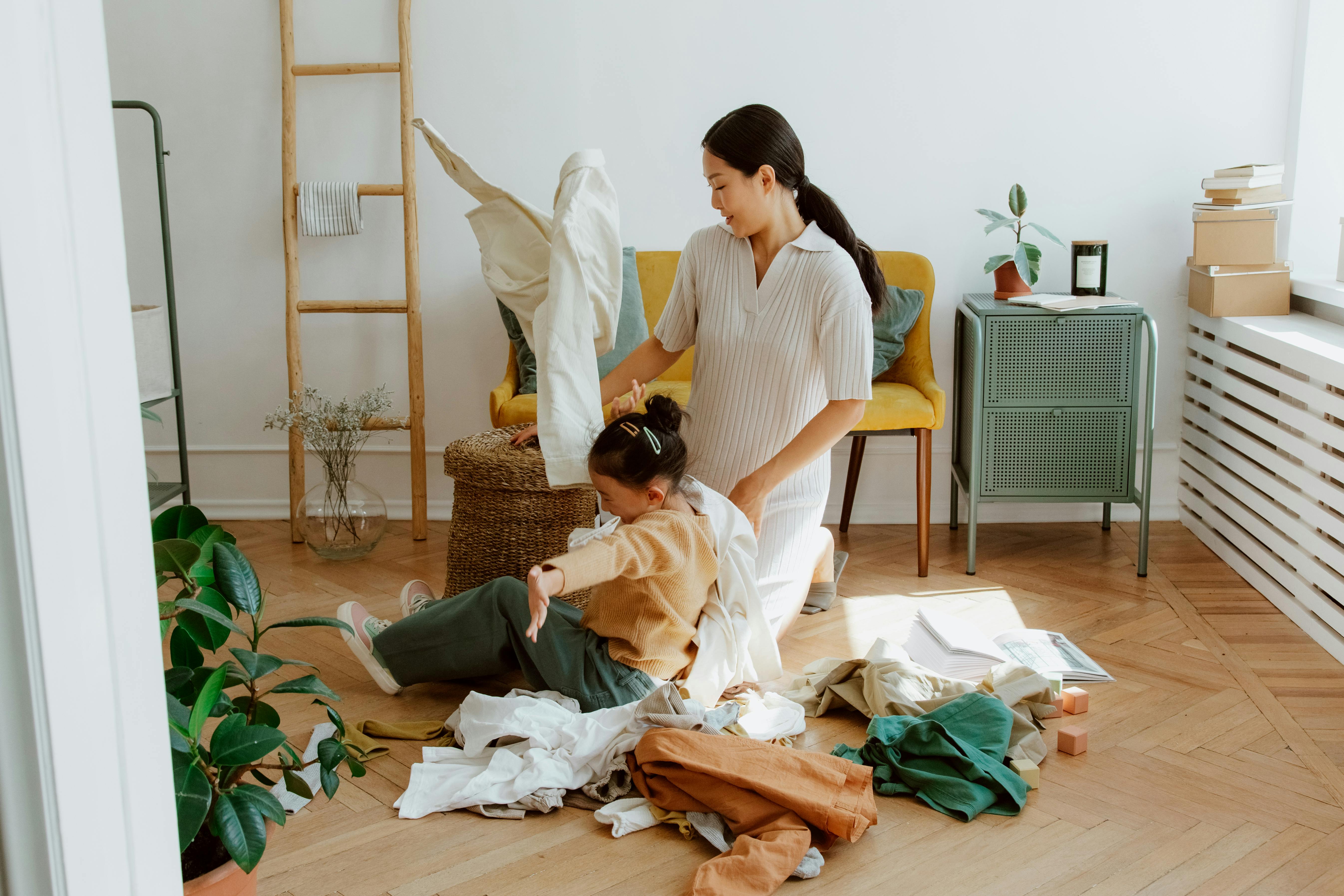 mother and daughter folding laundry