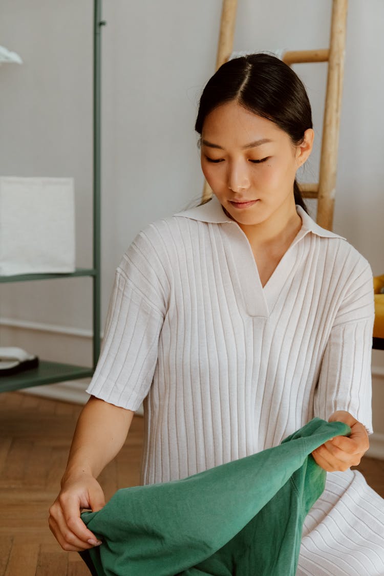 Black Haired Woman In Dress Holding Cloth