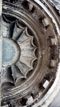 Highly detailed architectural bas relief with intricate carved patterns and textures on a stone facade.