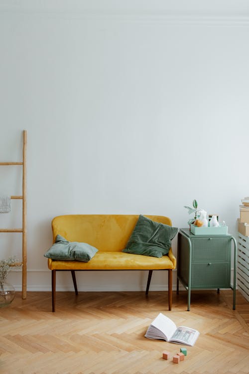 Pillows on Sofa and Toys on Wooden Floor in Living Room