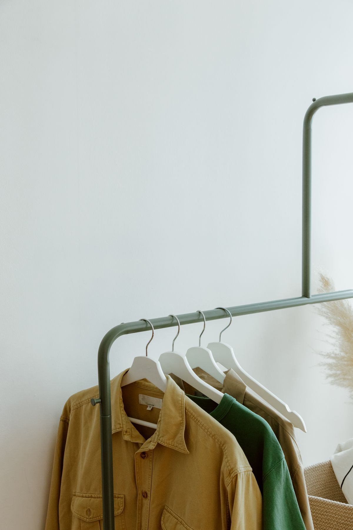 Minimal neutral wardrobe items on a clean clothing rack