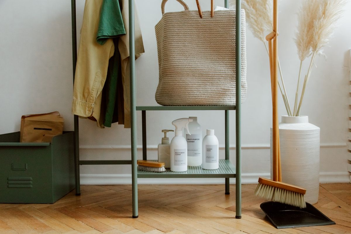Organized household cleaning products and storage basket on metal shelving