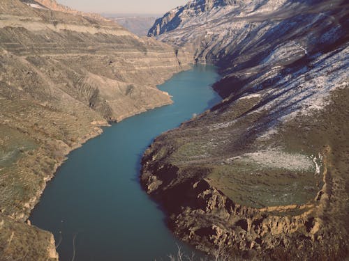 Aerial Photography of Lake in the Middle of Brown Mountains