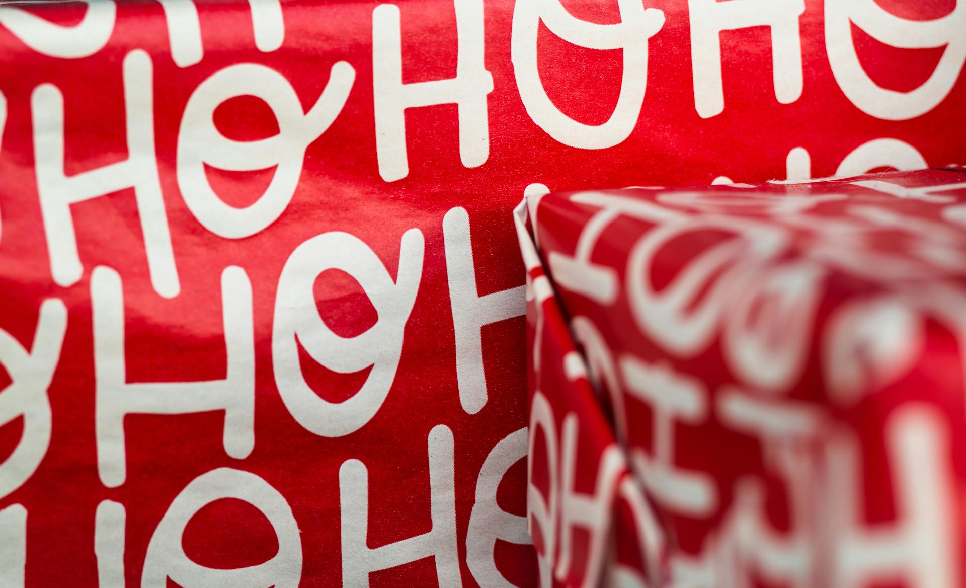 Red wrapping paper featuring festive Ho Ho Ho design, perfect for Christmas gifts.