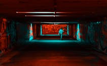 一条照明隧道内，涂鸦遍布，营造出戏剧性的场景，色彩对比大胆