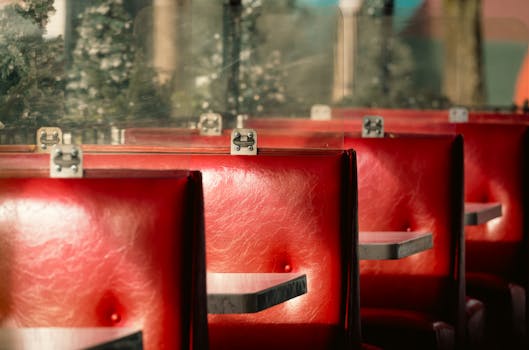 Red leather diner booths with retro charm, evoking vintage vibes and nostalgia.