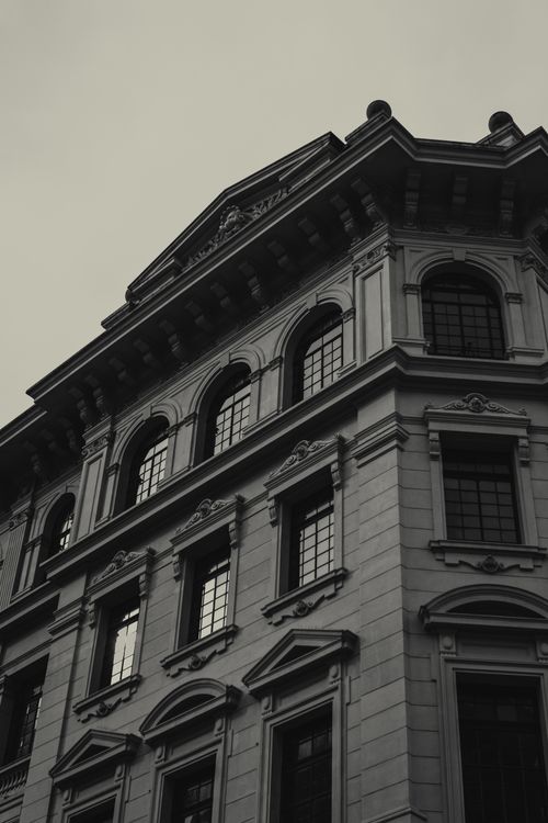 Free Elegant historic building facade captured in black and white, showcasing ornate architectural details. Stock Photo