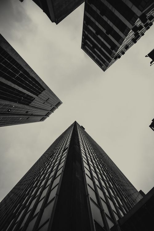 Free Dramatic black and white view of modern skyscrapers from a low angle perspective. Stock Photo
