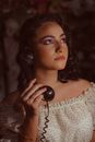 A Woman Holding a Corded Telephone