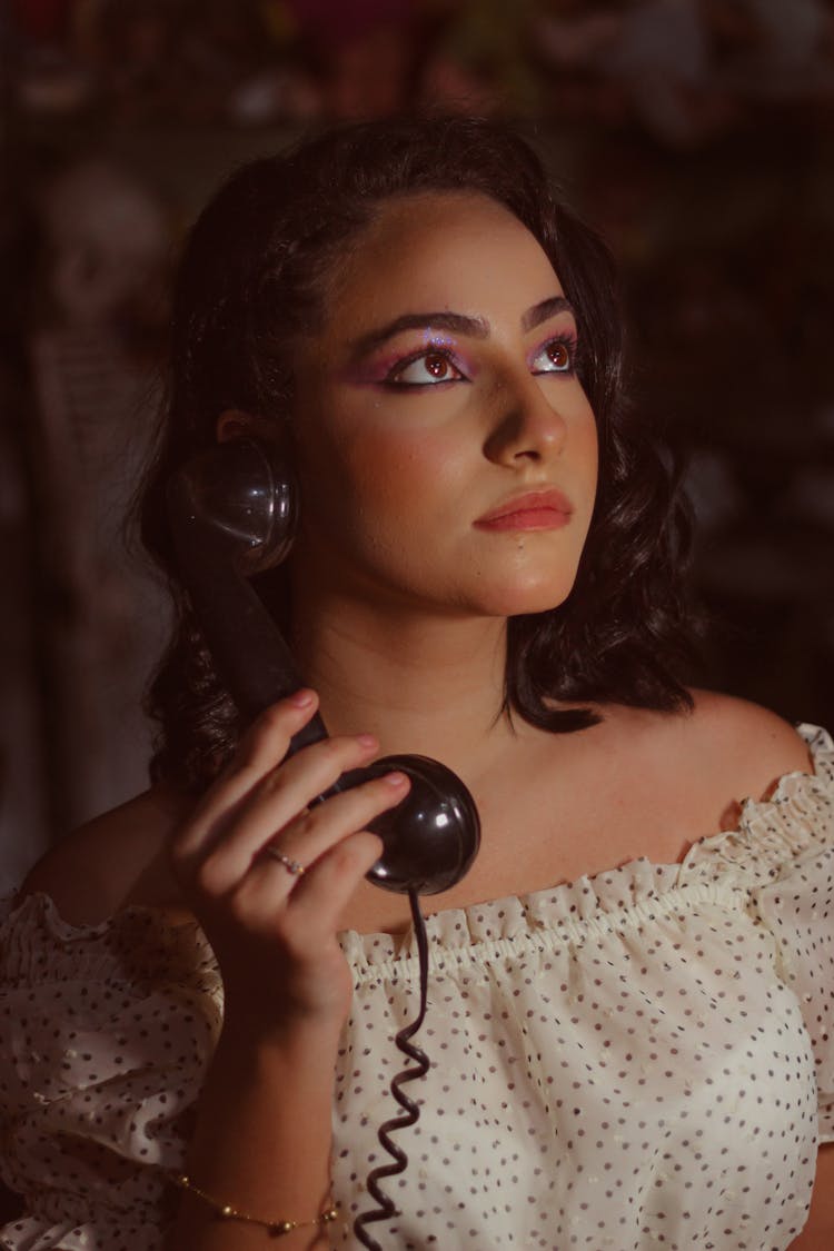 A Woman Holding A Corded Telephone