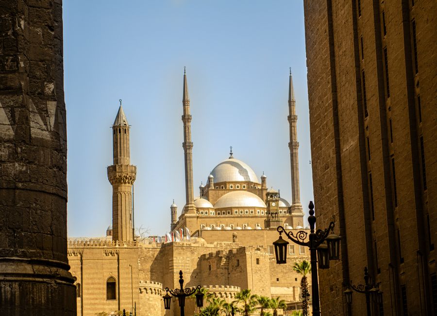 A stunning view of a mosque in Cairo featuring elegant minarets and a dome roof.