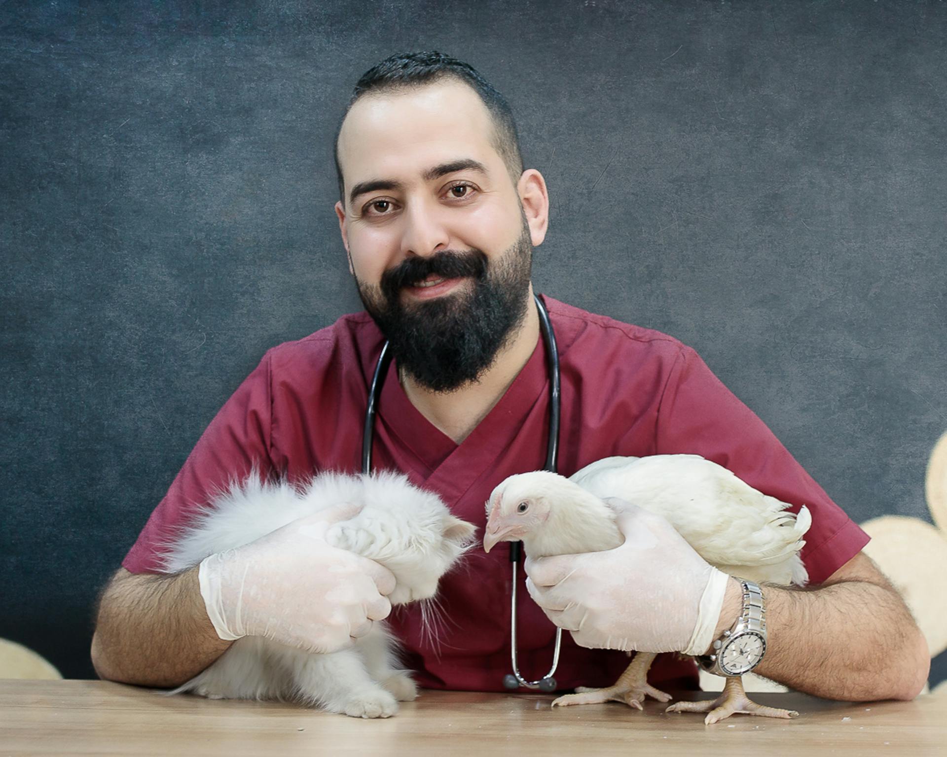 A MAn in Red Shirt Holding a Cat and a Chicken