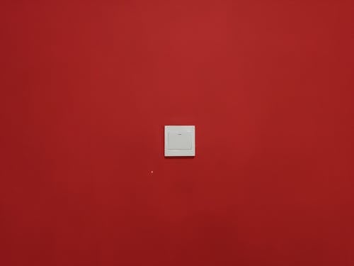 Free White Square Light Switch on a Red Wall Stock Photo