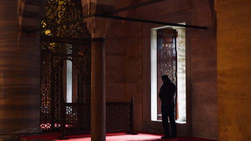 Free A man stands thoughtfully inside a historic mosque in Istanbul, showcasing Islamic architecture. Stock Photo