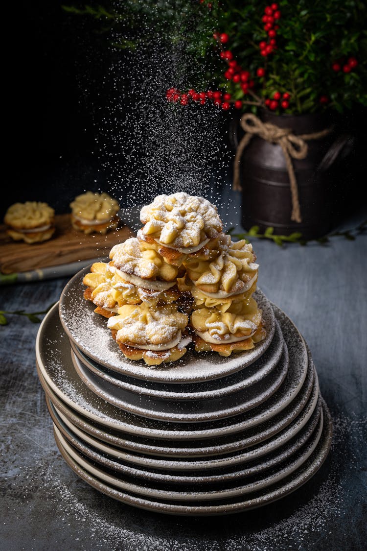 Cakes With Cream On A Stack Of Plates 