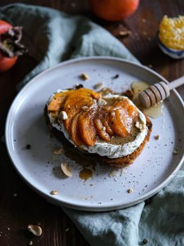 Delicious honey and persimmon toast with ricotta, captured in Istanbul's cozy ambiance.