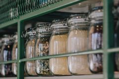 Neatly arranged glass jars with dry ingredients on a kitchen shelf, enhancing storage and organization.
