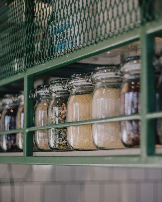 Neatly arranged glass jars with dry ingredients on a kitchen shelf, enhancing storage and organization. - Environmental Factors Affecting Dry Fruit Freshness