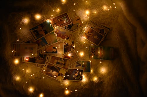 Free Cards on a White Surface Surrounded by Lights Stock Photo