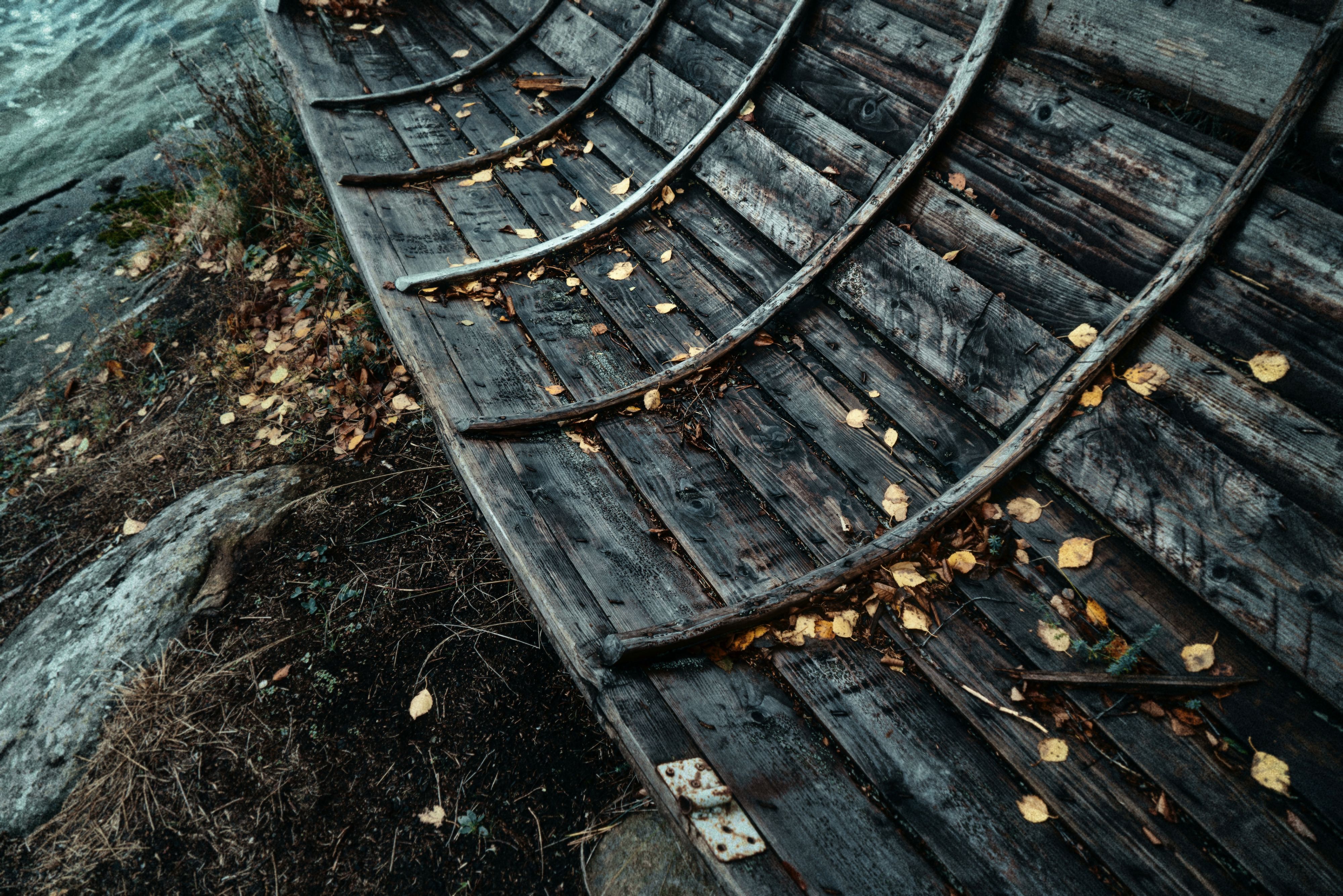 Old and Weathered Wooden Boat on a Riverbank · Free Stock Photo