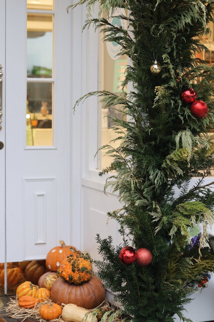 A Halloween Decoration On A Corner Near A Christmas Tree With Baubles